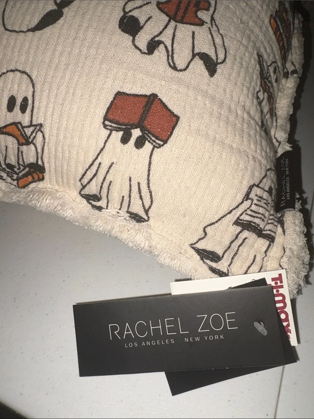 Rachel Zoe Cream reading Ghost Print Throw Pillow with Orange and Black Details